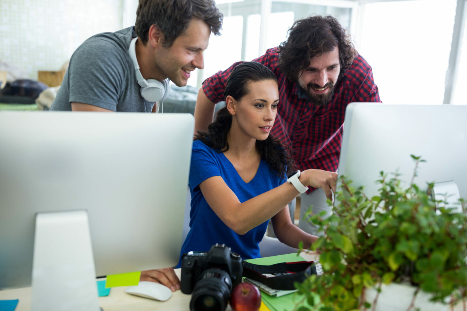Team of graphic designers working at desk in office